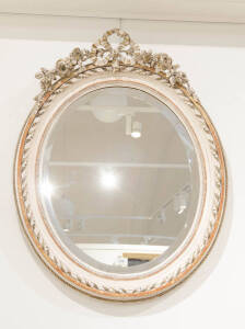 A pair of French cream finished ornate oval mirrors, 20th century. 85 x 65cm