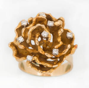 A diamond floral dress ring. Of textured finish and set with small brilliant cut diamonds. 18ct yellow gold. Weight 14.20 grams. Size O.