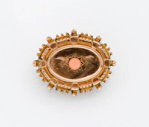A Victorian coral set brooch. The oval brooch with locket insert. 10ct Yellow gold.
