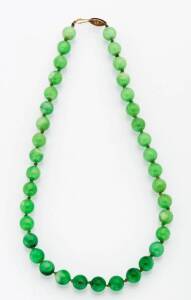A jade bead necklace. The 37 round jade beads of 9.2mm. Silver gilt clasp.