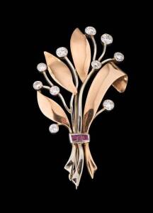 A diamond and ruby brooch. 14ct rose and white gold