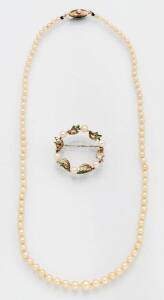 A pearl necklace and pearl brooch.&nbsp;