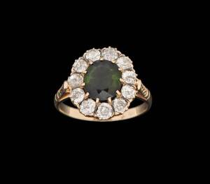 &nbsp;A tourmaline and diamond cluster ring. The oval green tourmaline surrounded by old cut diamonds. 18k rose gold. Size L.