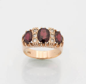 A garnet and diamond band ring. 9ct Yellow gold. Size P&frac12;.