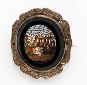 A micro mosaic brooch. Of oval form in scrolled setting. Sterling silver. Length 30mm.