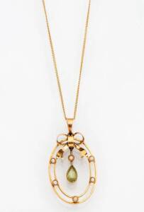 An Edwardian peridot and seed pearl pendant. The oval pendant with peridot drop. 9ct Yellow gold.