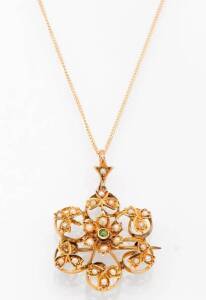 An Edwardian peridot and seed pearl floral pendant. 9ct yellow gold. Non original chain.