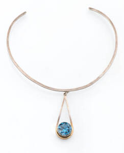 A contemporary Tor collar with blue stone drop. Sterling silver.&nbsp;