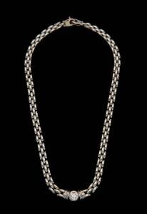 A diamond collar. The brick- link collar set with a single old brilliant cut diamond of estimated weight 1 carat. 18ct white gold. Weight 30 grams.