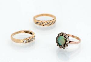 Three various rings including opal and white sapphire. Yellow gold.