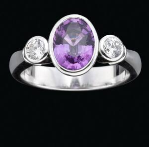 A sapphire and diamond three stone ring, 18ct white gold, size L.