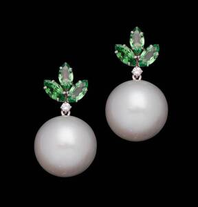 A pair of South Sea pearl and Tsavorite garnet earrings. The round silver South Sea pearls of 17.2mm suspended from a garnet and diamond cluster. White gold.