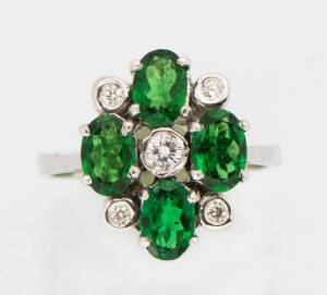 A tsavorite garnet and diamond dress ring. The oval garnets T.C.W. 2.80ct spaced with bezel set brilliant diamonds T.C.W.16ct. 18k white gold.