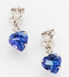 A pair of tanzanite and diamond drop earrings. The tanzanite drops T.C.W. 5.60ct suspended from a line of small brilliant diamonds T.C.W. 40ct. 18ct white gold.