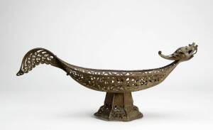 Indonesian pierced bronze dragon dish on stand. Length 62cm.