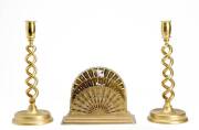 A pair of spiral brass candlesticks and brass fan shaped letter rack