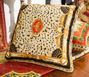 Four Versace style cushions and bed throw.