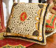 Four Versace style cushions and bed throw.