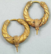 GOLD EAR ORNAMENTS: Pair of Bactro-Greek gold ear ornaments, Central Asia; each of loop form with spiralled gold foil decoration and granulated gold terminals. Circa 3rd-1st Century BC. 26-27mm diameter, 33-34cm long. Total weight: 11gms