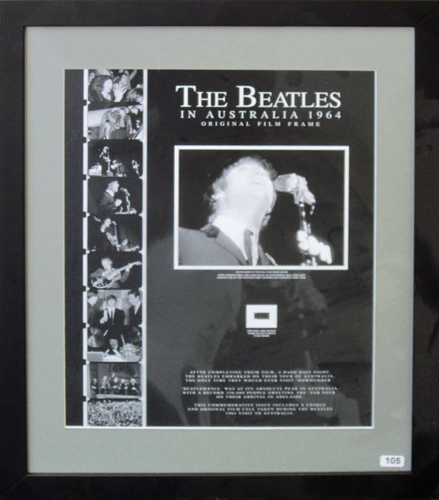 THE BEATLES IN AUSTRALIA 1964 - ORIGINAL FILM FRAME: Display with original 16mm film frame, with enlarged print of image, "John Lennon takes the lead vocal at Centennial Hall Adelaide during one of The Beatles first Australian concerts June 1964", window