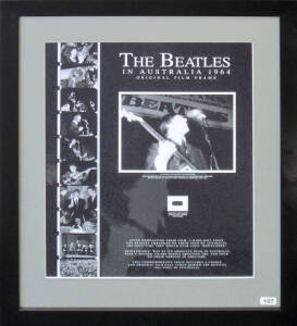 THE BEATLES IN AUSTRALIA 1964 - ORIGINAL FILM FRAME: Display with original 16mm film frame, with enlarged print of image, "Paul Macartney with his famous Hofner Bass in action at Centennial Hall Adelaide during one of The Beatles first Australian concerts