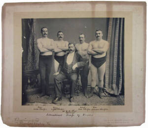 c1904-12 photograph by London Stereoscopic and Photographic Company Ltd, titled "International Troupe of Wrestlers. Bain, Scotch Champion; Green, English Champion; Carrol, Irish Champion; Ross, American Champion; Mr.W.H.Shaw, Manager", size 40x35cm. Fair/