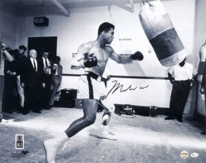 MUHAMMAD ALI, signed photograph of Muhammad Ali with punching bag, size 51x40cm.