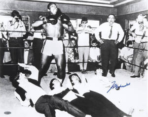 MUHAMMAD ALI & THE BEATLES, photograph of Ali standing over The Beatles, signed "Muhammad Ali", size 51x40cm.