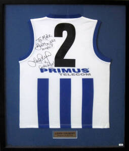 LEIGH COLBERT (Geelong/North Melbourne), signature & endorsement on North Melbourne football jumper, framed & glazed, overall 79x103cm.