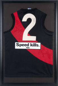 ESSENDON: Essendon football jumper (with no."2" on reverse) with 8 signatures including Mark Mercuri, Kevin Sheedy, Dustin Fletcher & Michael Long, framed & glazed, overall 66x97cm.