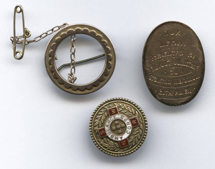 9ct GOLD MEDALS/BADGES, noted 1910 oval medal "Dux Medal, Presented by Provost Johnstone to Stonelaw, H.G.School, Rutherglen"; 1943 "NSWR Ambulance Corps" gold & enamel pin/medal; circular brooch. Total weight 10.33 grams.