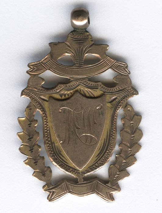 ALBURY GAOL, 9ct gold fob/medal with initials MW on front, engraved on reverse "Presented to M.Wallace, as a token of esteem, From the staff of Albury Gaol 1'1'13". Weight 5.89 grams.