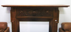 FIRE SURROUND: Carved oak with floral panel. Height 130cm, width 172cm.