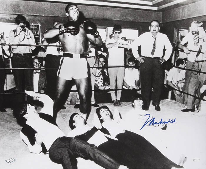 MUHAMMAD ALI & THE BEATLES, photograph of Ali standing over The Beatles, signed "Muhammad Ali", size 51x40cm. With 'Online Authentics' No.12476.