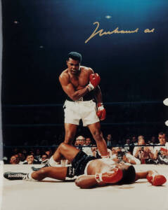 MUHAMMAD ALI, signed colour photograph of Ali standing over Sonny Liston, size 28x35cm. With CoA.