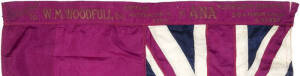 SILK AUSTRALIAN FLAG, endorsed in gold "Presented to W.M.Woodfull Esq, Captain Australian XI 1934, By ANA, Metropolitan Committee, Syd G.Herron, Chairman, 5/3/1934", size 140x66cm. The flag is a deep magenta colour, with a few minor moth-holes, otherwise 