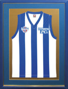 NORTH MELBOURNE: North Melbourne football jumper with "AFL/100/Centenary/Grand Final" logo on right breast, window mounted, framed & glazed, overall 80x109cm.