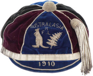 DALLY MESSENGER'S 1910 KANGAROOS CAP, in blue, black & maroon, with metal embroidery on front "AUSTRALASIA/ RFL/(Kangaroo & Silver Fern)/1910", and tassle on top, with initials "H.H." inside. In very good condition, with slight deterioration to two cloth 