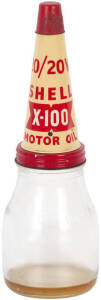 SHELL X-100 Oil bottle: 20/20W X-100 Pint bottle with capped lid in above average to excellent condition. A great piece of petroleum memorabilia. (30 x 11cm)