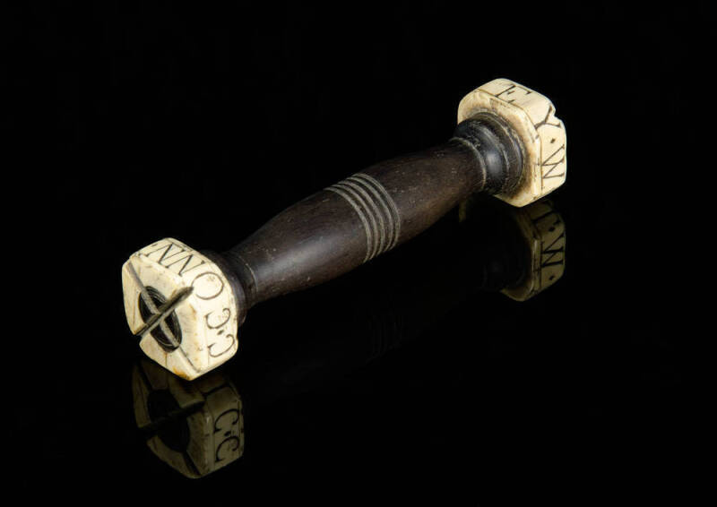 An unusual whalebone and turned wood sailor’s love token, 19th century;engraved to one end ‘MYSTIC*CONN’ and at the other end with the name of the sailor ‘W*T*RAMSEY’ 14.2cm long