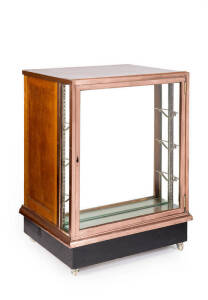An unusual copper bound shop display cabinet fitted with 4 drawers on the reverse. Tasmanian oak, copper & glass, early 20th century (later casters). Height 104cm, width 76.5, depth 60.5cm