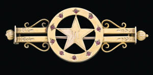 A gold redstone star double bar brooch, Larard and Son, Melbourne, set with garnet topped doublets marked 15ct, length 6cm.&nbsp;