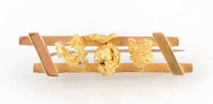 A double bar brooch set with three nuggets, marked 18ct, length 5.4cm. Weight 11.25 grams.