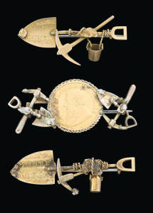 Three South African goldfields brooches, indistinct makers mark on one, one marked 9ct, the coin brooch not marked, average length 4.5cm.