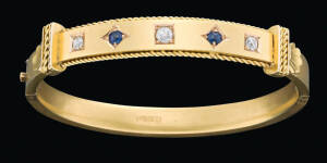 A gold, sapphire and diamond bangle by Flavelle, Roberts and Sankey, Brisbane, original box, stamped 18ct, inside diameter 5.6cm.