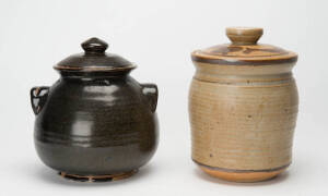HAROLD HUGHAN: Two pottery cannisters, brown & black glazes. Both with full signature & additional monogram. Tallest 23cm