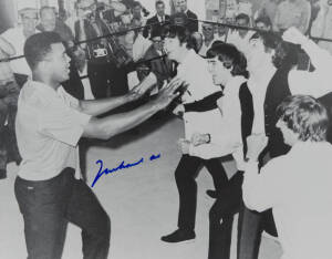 MUHAMMAD ALI & THE BEATLES, photograph of Ali clowning around with The Beatles, signed "Muhammad Ali", size 51x40cm. With CoA No.0552.