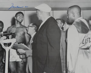 MUHAMMAD ALI, signed b/w photograph of Ali at weigh-in with Sonny Liston, size 51x41cm.