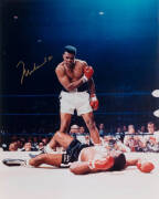 MUHAMMAD ALI, signed colour photograph of Ali standing over Sonny Liston, size 41x51cm.