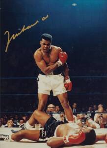 MUHAMMAD ALI, signed colour photograph of Ali standing over Sonny Liston, size 28x35cm. 